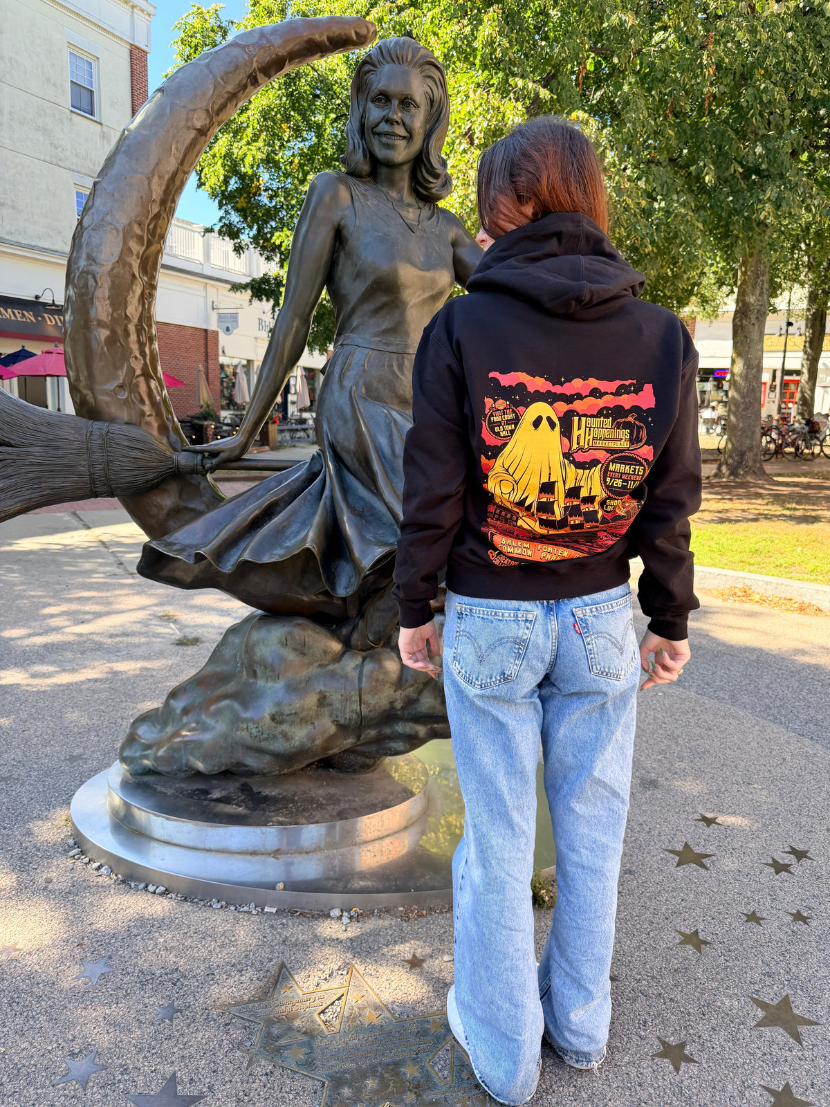 Back of the black 2026 Kaiju Ghost hooded sweatshirt with a large gold ghost and sailing ship design.